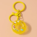 Macro detail of yellow lifebuoy donut keychain featuring unique Chinese typography design - Yellow