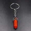 Macro detail of hexagonal orange stone pendant with polished silver alloy keychain - Red Jasper