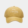 Close-up of mustard yellow washed canvas baseball cap with embroidered white text - Adjustable / Yellow