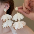Detailed view of large double-layer white chiffon petal tassel earrings on a model - 85# Steel Needle - Beige
