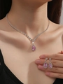 Model wearing a bridal jewelry set featuring pink teardrop gems and zircon accents - 463 Necklace Stud Earrings Set / Pink