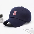 Dark blue baseball cap featuring a gothic red letter K embroidery on a curved brim hat - Adjustable / Navy Blue