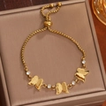 Bracelet ajustable en acier titane doré avec papillons 3D et détails en zircone - Or