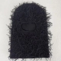Macro detail of black knitted balaclava mask with unique shaggy fringe texture - One Size / Black