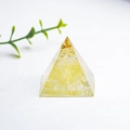 Resin pyramid decor with yellow crystal stones and gold foil flakes on white background - Lemon Yellow