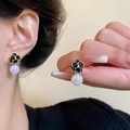 Elegant black camellia stud earrings with golden edges and iridescent pearls - Black Camellia Iridescent Pearl Drop Earrings