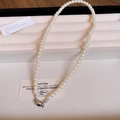 Elegant single strand pearl necklace with a silver spherical clasp on beige velvet - White-6mm