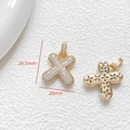Macro detail of gold-plated flower pendant with white zircons and dimensions of 28.5mm - Letter X