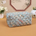 Quilted makeup bag featuring blue vintage floral prints and metal ring zipper closure - Garden Light Blue