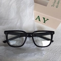 Kids black square frame sunglasses with silver star detail on a gift paper background - Black Frame Clear Lenses