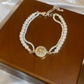 Détail du bracelet double épaisseur en perles avec pendentif étoile sur soie et bois - Style Cadeau Double Strass Étoile Octogonale / Or/Blanc