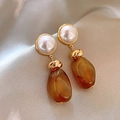 Close-up of pearl flower earrings with amber resin pendant on champagne silk fabric - Gold Brown Long Teardrop Dangle (37#)