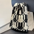 Knitted tote bag with black and white cartoon bunny pattern hanging on a chair - Black and White Rabbit