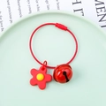 Macro view of red wire keychain with a small flower pendant and matching bell charm - Wire Ring + Soft Flower + 22mm Bell / Red