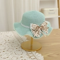 Dettaglio di un cappello di paglia verde menta con fiocco floreale e bordo in pizzo - S (Bambini 52cm 1-6 anni) / Cappello Verde Menta