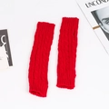Detailed knit texture of long fingerless red acrylic arm warmers in cable stitch - One Size / Red