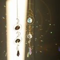 Dual suncatcher set with metallic crescents and faceted crystal prisms creating rainbow light - Design No.8