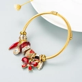 Detail of gold-tone wrap bracelet featuring a red crystal butterfly and sparkling red beads - Red