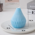 Light blue geometric scented candle with vertical ridges on white marble tray - Pear Spiral Blue (Rosemary Mint)