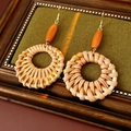 Detail of bohemian round rattan earrings with oval wooden beads and gold metal hooks - Ear Hook-Coffee