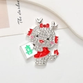 Detailed macro view of a sparkling dragon brooch with white rhinestones and red enamel - Dragon Joy - Silver