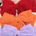 Oversized bow hair clips in deep red, orange and light purple with raised polka dot texture - Orange
