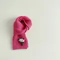 Detail of rose red ribbed knit scarf with a cute 3D cartoon bear patch and soft texture - Rose Red
