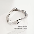 Detail view of silver irregular wave bracelet on white stone with weight and size specs - Irregular Wave Polished Open Bangle (SL221) / Silver