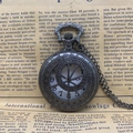 Vintage bronze pocket watch with hollow roman numeral dial on retro newspaper background - Hollow Out / Black