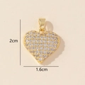 Macro view of gold heart pendant with cubic zirconia inlay and 2cm by 1.6cm dimensions - 0228-8/Gold Simple Zirconia