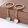 Cute heart shaped Evil Eye keychains with mint green and pink enamel in gold alloy - Two-Piece Set / Evil Eye Keychain