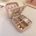 Pink PU leather macaron jewelry box showing internal necklace hooks and ring slots - Pink