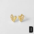 Detailed macro view of heart-shaped gold earrings with three pearls inlay design - Style D-Hollow Heart