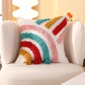 Rainbow tufted stripe pillow in cream with pink and blue tassels on a plush armchair - Tufted-Rainbow Stripes (Cover Only) / 18x18 Inch