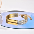 Gold stainless steel bracelet with rectangular crystals and heart charm on a mirror surface - Style 6 (Gold ID Plate Bracelet)