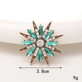 Vintage-Sternbrosche aus Bronze mit grünen Marquise-Steinen und weißen Akzenten - Seesternblüte (Grün)