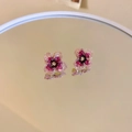 Detailed mirror shot of pink floral beaded earrings with delicate crystal petals - Red