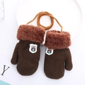 Detail of brown knitted toddler mittens with faux fur trim, shield patch, and neck string - 1-4 Years / Coffee
