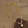 Detailed view of golden heart pendant necklace with white pearls on a rustic background - Gold Flower Heart Pearl Necklace
