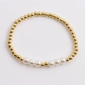 Elegant gold beaded bracelet with white pearls on a clean light background view - Gold/White
