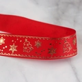 Macro shot of red grosgrain Christmas ribbon with gold snowflake and tree foil patterns - 2.5cm Gold Rim Christmas Red (22 Meters)