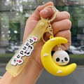 Detail of cute panda on yellow moon keychain with stylish translucent silicone wrist strap - Cosplay Panda - Crescent Moon