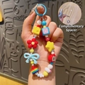 Colorful hand-painted beaded phone charm with red flower and blue bow accents - Red - Dopamine Phone Chain