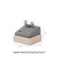 Detail view of a 5.5cm square gray microfiber stud earring display stand with base - Square Base Earring Stud Holder