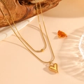 Close-up of 18K gold-plated double-layer necklace with heart pendant and bead detail - Gold Heart Shaped Necklace (C815)