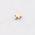 Macro shot of a golden puzzle piece pendant on a marble background for jewelry making - 10*10mm / 18K Gold Plated