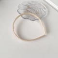 Minimalist beige marble acetate headband with elegant tortoiseshell finish on white background - Off-white