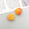 Close-up of two cute orange resin bread charms with metal rings on gray background - 1Pc Peeled Yellow Orange