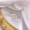 Detail of freshwater pearl ring with a gold letter W pendant on a silk and mirror surface - Letter W