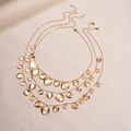 Detailed view of triple-layered golden necklace with textured circular metal pendants - Gold (3-Piece Set)